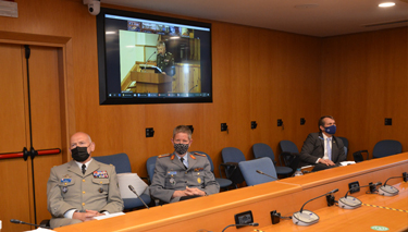 (Left to right) LGEN Olivier Rittimann, BGEN Rolf Wagner and Dr Stephen J. Mariano during the International Week in Kyiv closing remarks by LGEN Viktor Tarasov (screen), NDUU 1st Deputy Commandant