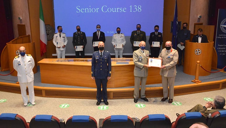 Winning Committee of the Eisenhower Prize, SC 138 Committee Number 7. (First row, r to l) NDC Commandant LGEN Olivier Rittimann, Committee Chair COL Chris Gent, Secretary LTC Teemu Pöysti, Faculty Adviser CAPT Paolo Inacio, Mentor Dr Andrea Gilli; (Podium, r to l) NDC Dean Dr Stephen J. Mariano at the lectern, LTC Takanao Tamura, LTC Stavros Psofidis, CDR Federico Martinez Gaude, Mr Oğuzhan Yildirim, LTC David Nesvik Henriksen and CAPT Matthieu Delafoy.