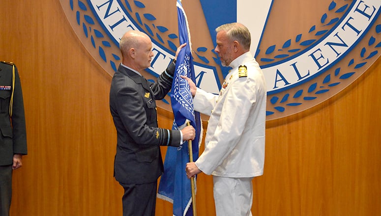 Transferring the NDC flag from the outgoing Commandant, LGEN Rittimann, to the incoming Commandant, LGEN Nielsen