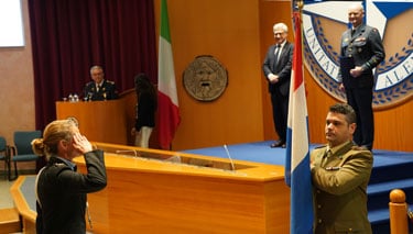 NRCC 33 Course Member saluting her Country Flag before receiving the graduation diploma