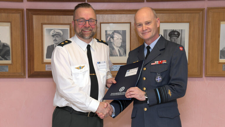 Course Member receives his diploma from Lieutenant General Nielsen